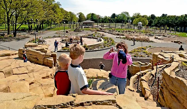 Kids play atop the rock wall in the Nature Play Area and Discovery Garden at Tamarack Nature Center in White Bear Township on April 25, 2012. (Pioneer Press: Richard Marshall)