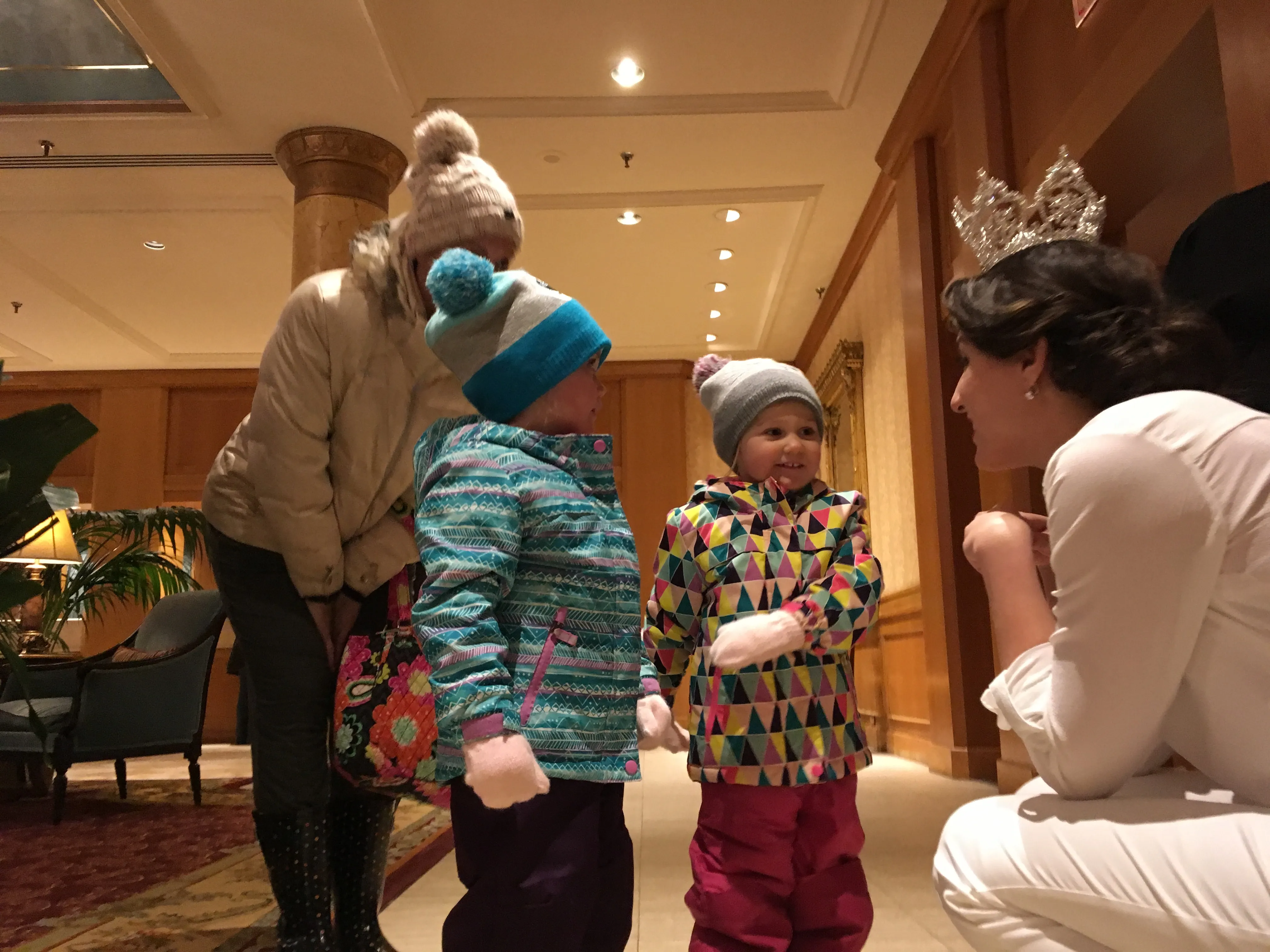 Jilla Nadimi, 2018 Queen of Snows of the St. Paul Winter Carnival, chats with 3-year-old twins Avery McKane (left) and Skylar McKane of Farmington in the lobby of the Saint Paul Hotel on Saturday, Jan. 27, 2018, the day after she was crowned. (Molly Guthrey / Pioneer Press)