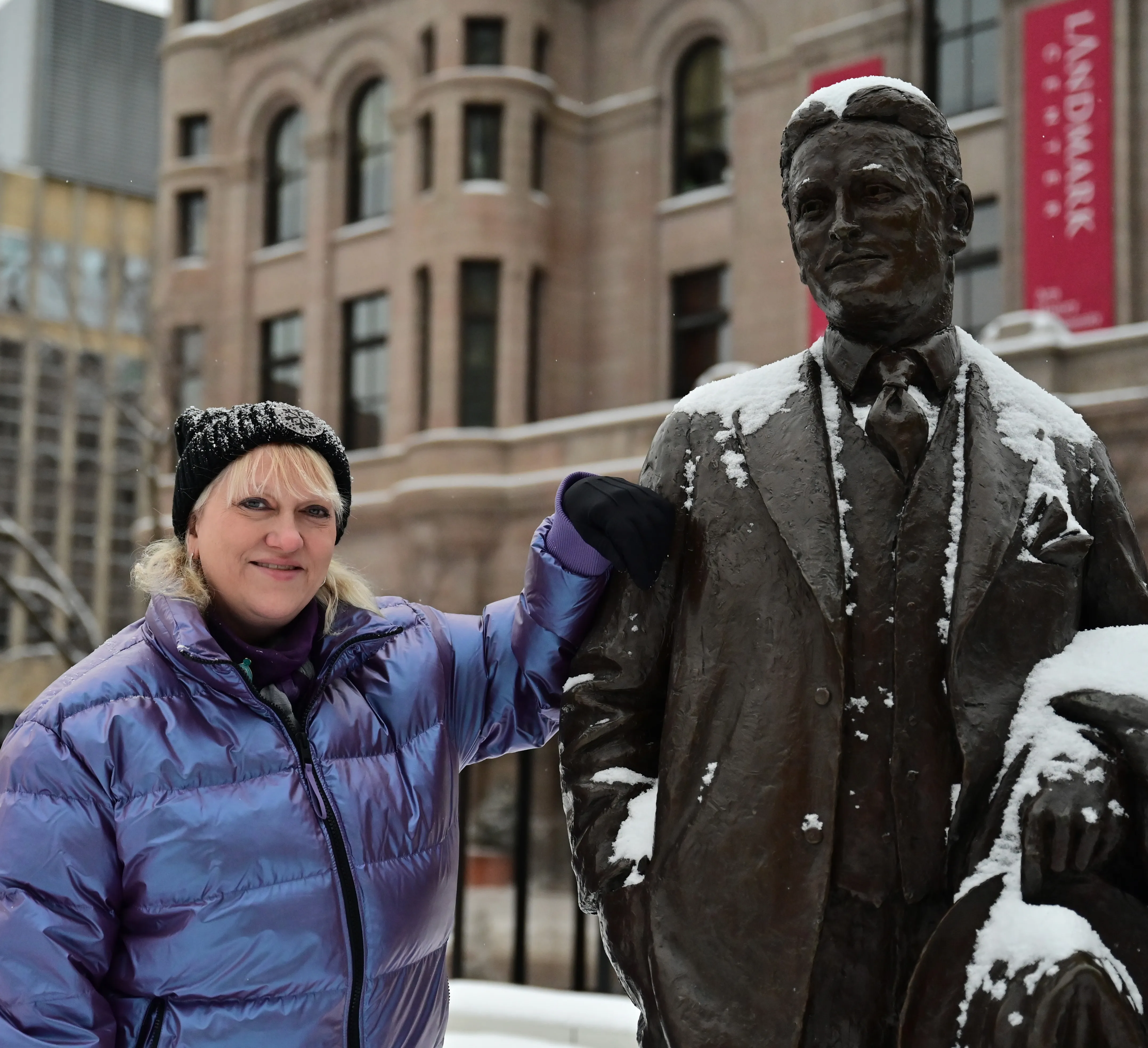 Lisa Jacobson, St. Paul Winter Carnival CEO, hangs out with the statue of famed St. Paul author F. Scott Fitzgerald at Rice Park in St. Paul.