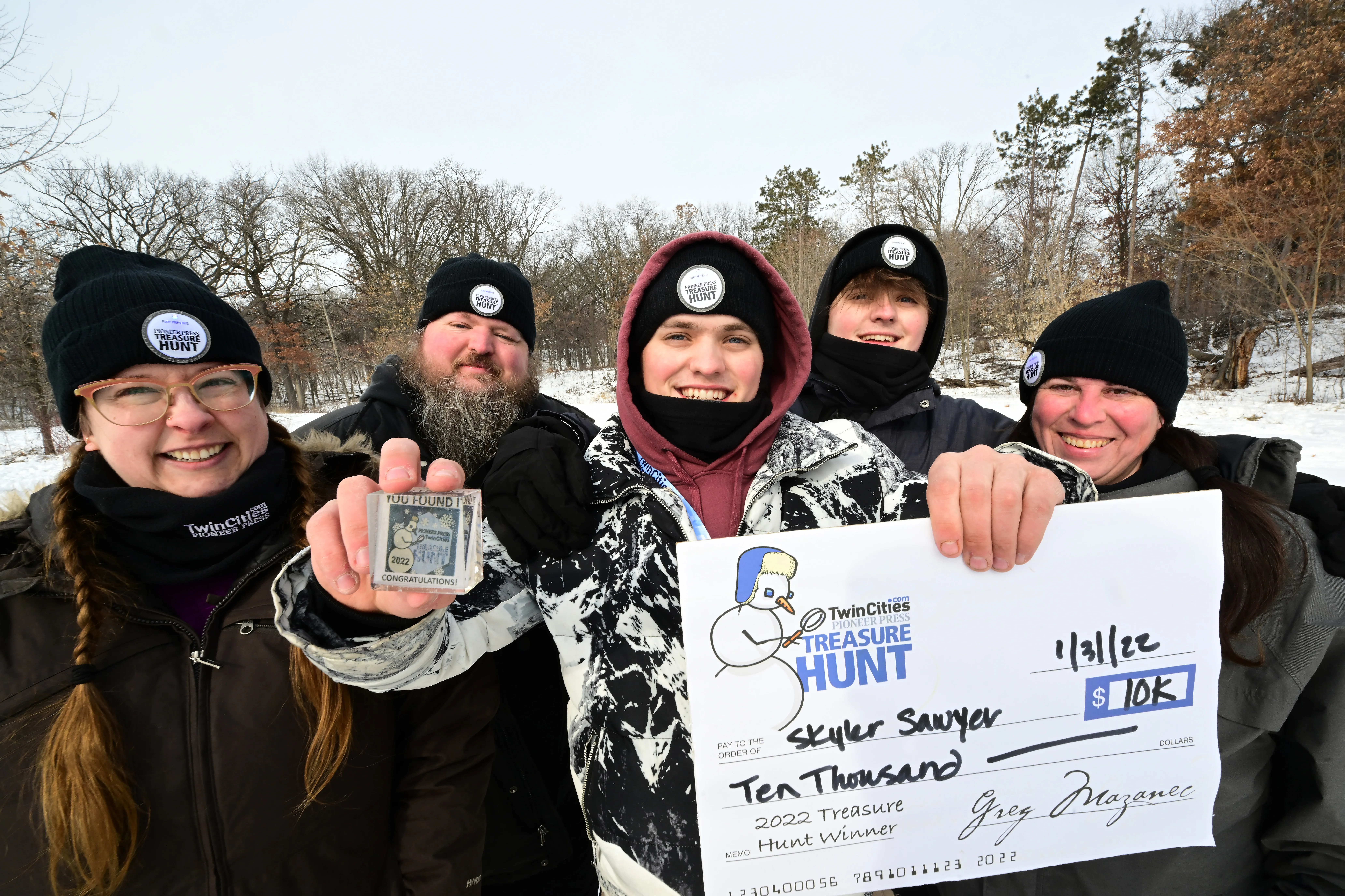 Skyler Sawyer, center, is joined by his stepmom Liz McMann, from left, his dad Michael, his brother Griffen and friend Emily Malcolm for a photo after Skyler found the Pioneer Press Treasure Hunt medallion at Silverwood Park in St. Anthony on Monday, Jan. 31, 2022. The St. Paul family are avid treasure hunters.