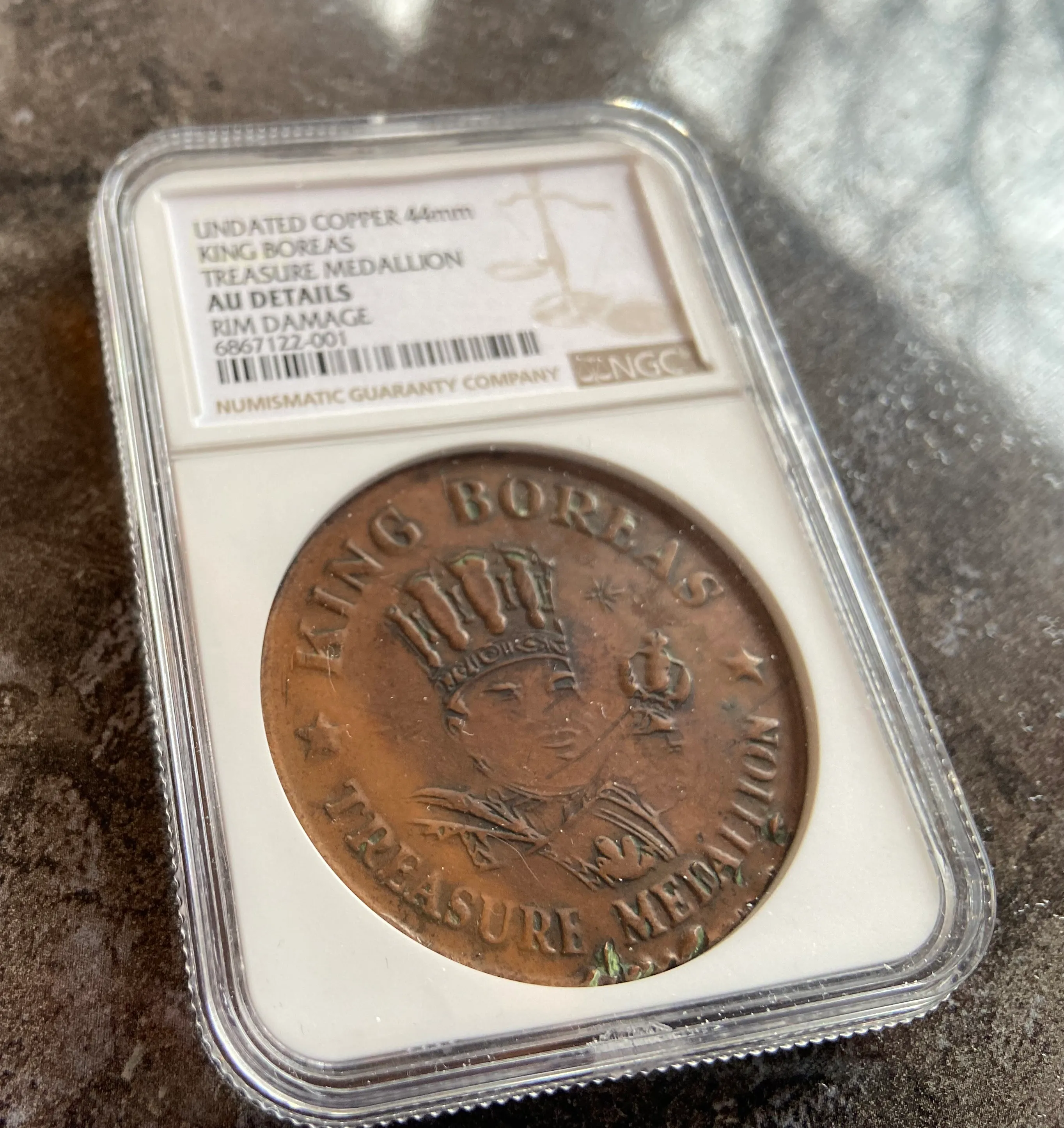 A brass coin, believed to be an original Pioneer Press Treasure Hunt medallion, is shown on Jan. 10, 2024 in Roseville. The medallion is currently listed for sale on eBay; the identity of the seller and details on how the medallion left the Pioneer Press' ownership are not known. (Jared Kaufman / Pioneer Press)