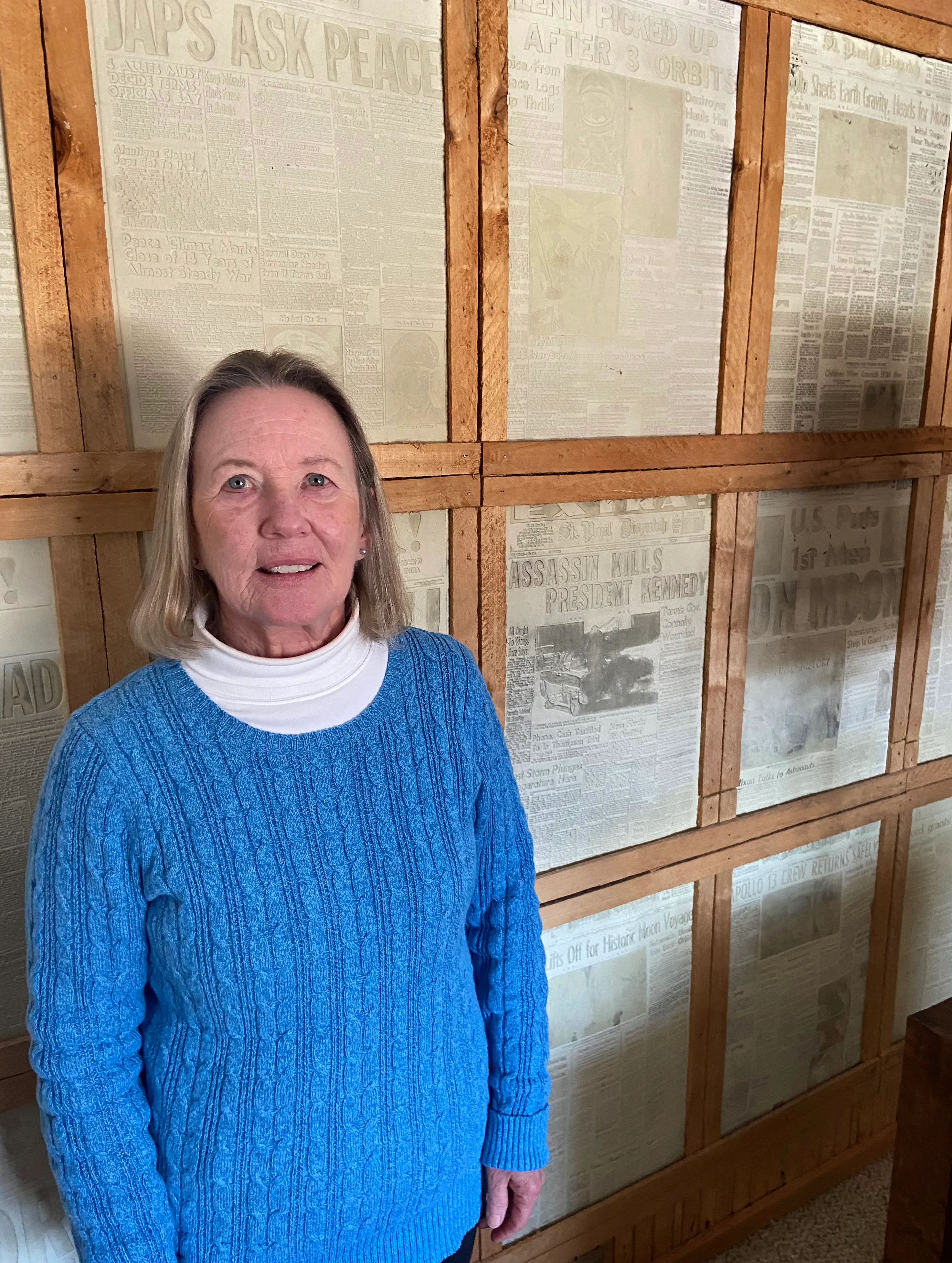 Former Pioneer Press marketing executive Diane Moser in front of a wall display of historic Pioneer Press and St. Paul Dispatch stereoplate printing molds at her home in Osceola, Wis., on Jan. 16, 2024. Moser and her late husband, Jack, ran the Pioneer Press Treasure Hunt for many years between the 1970s and early 1990s. (Jared Kaufman / Pioneer Press)