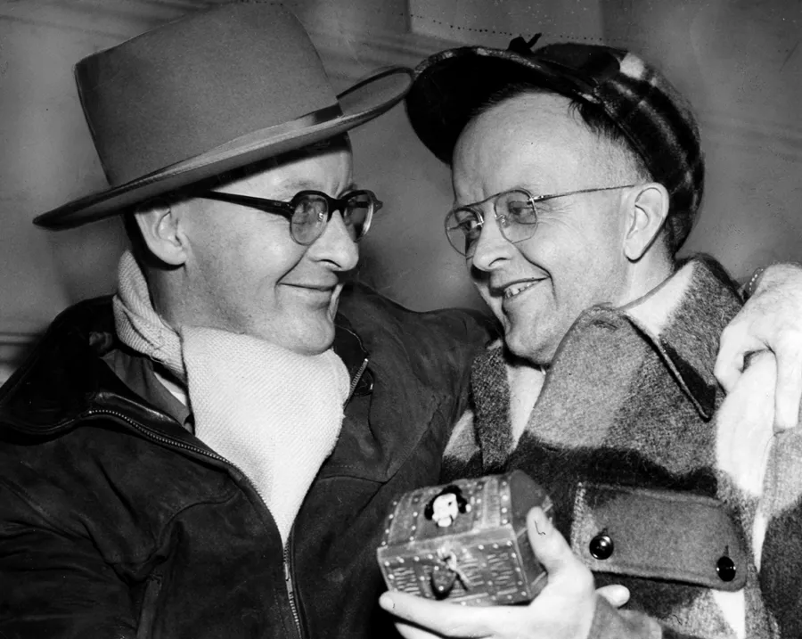 Brothers Henning, left and Arthur Jensen of St. Paul celebrate finding King Boreas' Treasure to end the first Pioneer Press Treasure Hunt on Feb. 1, 1952. Arthur found the chest while digging through the snow in St. Paul's Highland Park. (Roy Derickson / Pioneer Press)