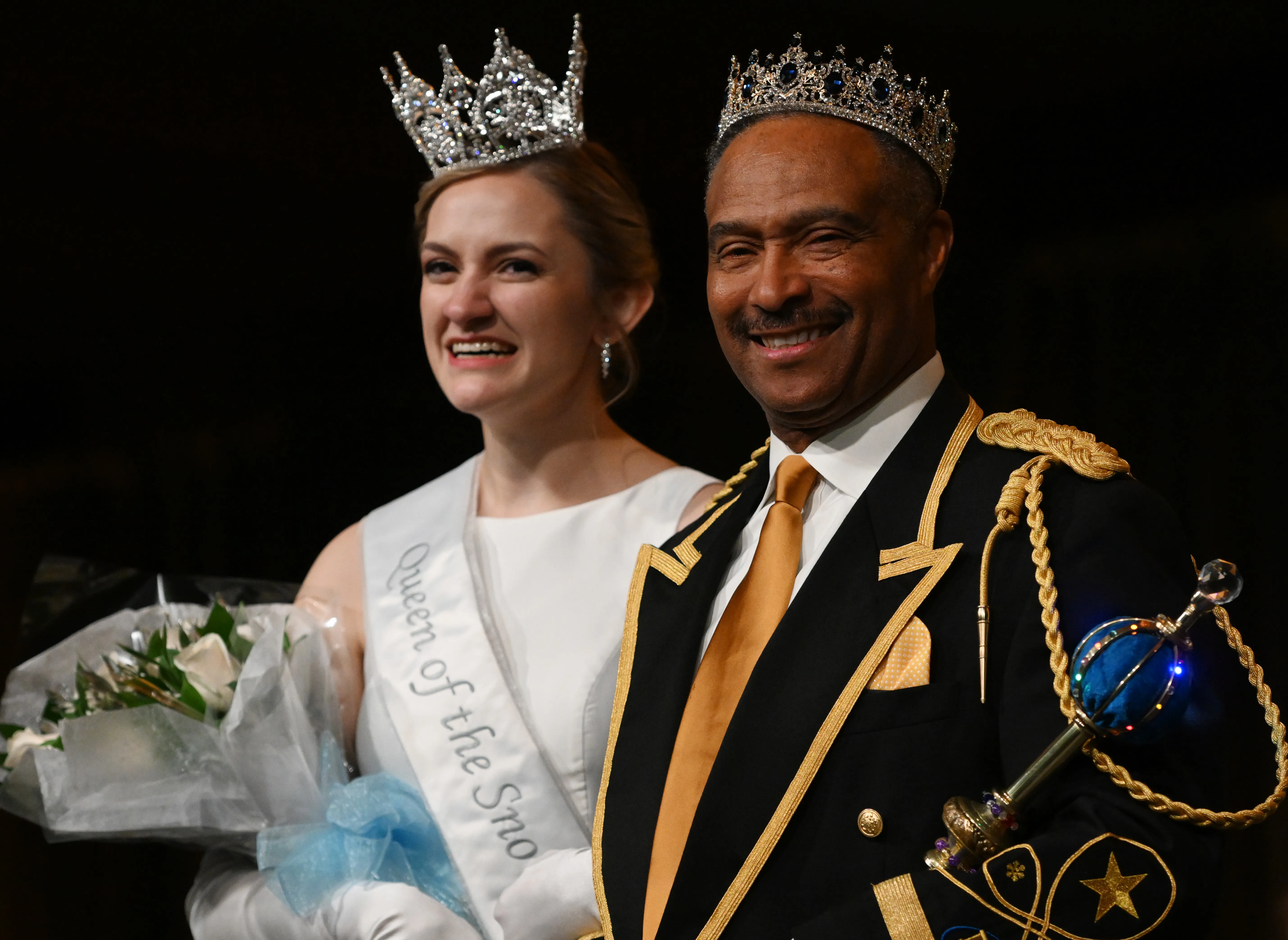 A man and woman in royal garb and crowns.