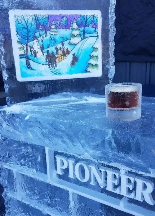 A beer in an ice mug on an ice bar.