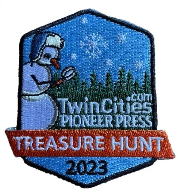 A patch with an illustration of a snowman holding a magnifying glass.