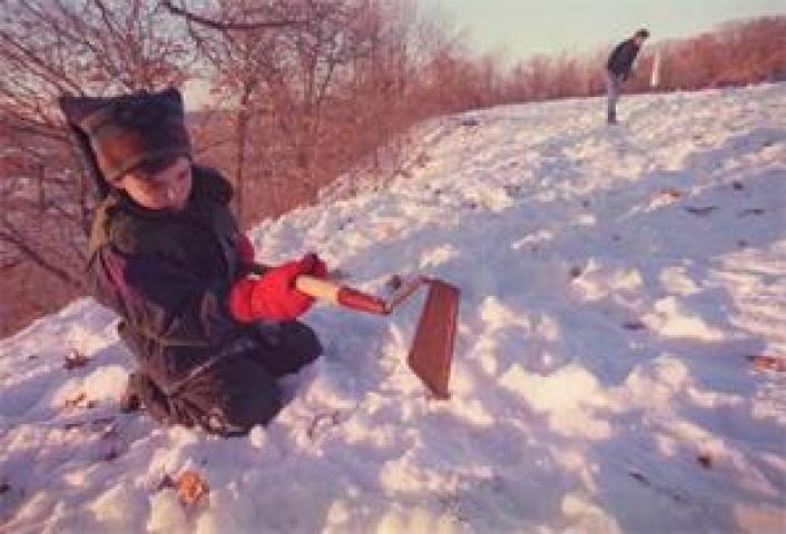Jordan Lundberg of St. Paul searches for the medallion on a hill in Cherokee Park in this 2003 Pioneer Press file photo. (Pioneer Press file photo)