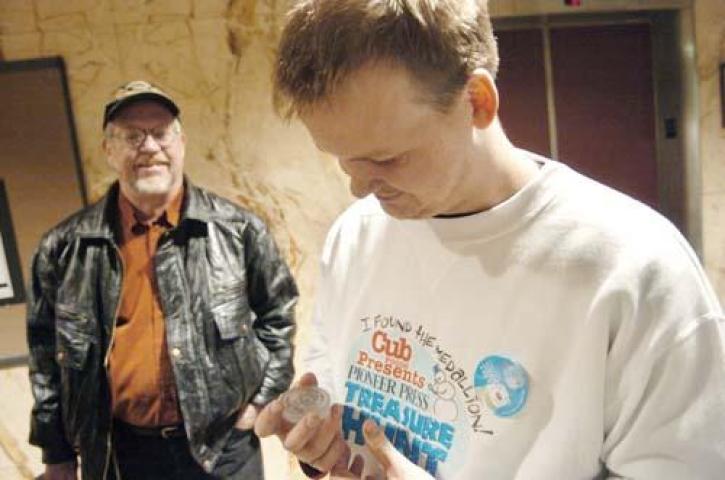 Jeff Ingebrigtson, left, watches his son Jake Ingebrigtson, right, looks at the Winter Carnival Medallion at the Pioneer Press in Saint Paul, Minn. Tuesday, Jan. 23, 2007. Jake found the medallion after only three clues. “You don’t understand how traumatic it is to find this. When you think about something so much–dream about it so much–when it happens you just can’t believe it, ” said Ingebrigtson.