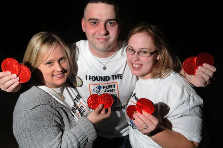 The 2011 Pioneer Press Treasure Hunt medallion was found at Battle Creek Regional Park by mother and daughter Mary, left, and Molly Hermes, right, of Woodbury and Molly's boyfriend Dan Murphy, middle, of St. Paul at 2:30 am Saturday morning at the popular park in St. Paul. The trio is holding up chocolate medallions made to look like the medallion. (Pioneer Press:Sherri LaRose-Chiglo)