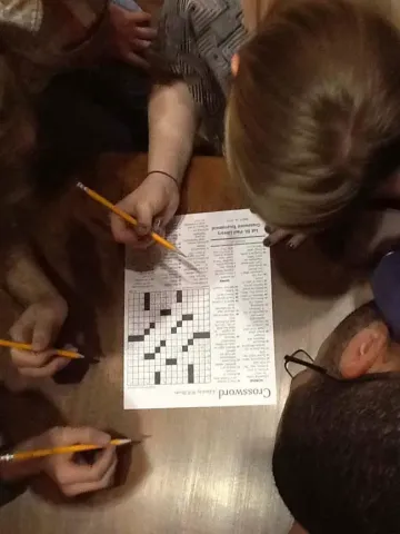 A team of competitive crossword puzzle solvers, including Martha Truax, top, and Ian Noble, right, labor over clues at the Minnesota’s first crossword puzzle tournament Friday night, March 30, in the James J. Hill Reference Library in St. Paul. (Pioneer Press: Richard Chin)