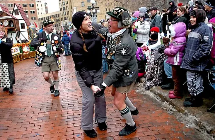 Robert Richardson,middle right, representing Octoberfest out of LaCrosse, WI, pulled Angela Brown, middle left, of Osceola, WI, out of the crowd to dance to German music piping from the Octoberfest float at Rice Park along 5th Street. The 2011 King Boreas Grande Day Parade lined 5th Street in downtown St. Paul during the first weekend of the St. Paul Winter Carnival on January 29, 2011. (Pioneer Press:Sherri LaRose-Chiglo)