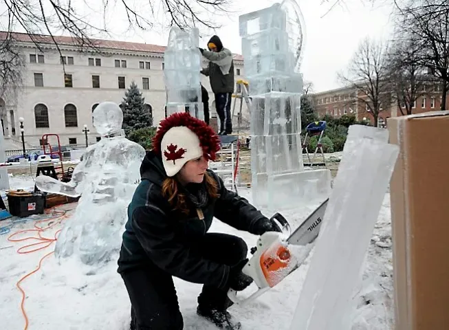 Eden Prairie resident Deneena Hughes saws pieces of ice to use in creating the piece "Breaking Free" in the Multi-block Ice Carving Competition during the 2012 St. Paul Winter Carnival in Rice Park. (Pioneer Press file)