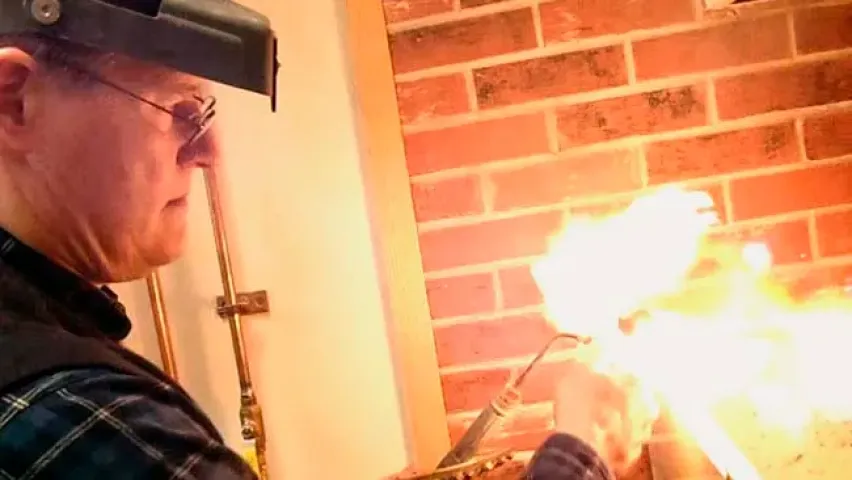 Todd Hawkinson works with a torch