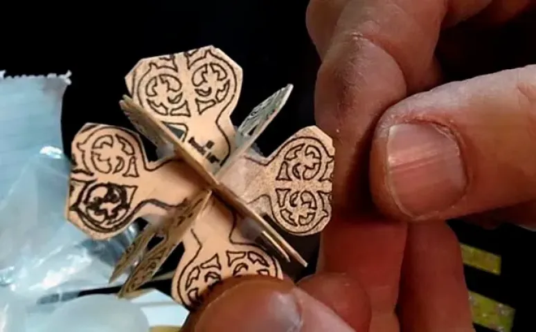 Todd Hawkinson works on a model insert for the medallion