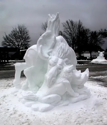 Mike Majerus of Rogers, David Ryding of Minneapolis, and Adam Turner of Arden Hills, sculpting as the team “Snow Cowboys” won First Place and Artists Choice in the snow sculpture contest for the 2013 St. Paul Winter Carnival. Their sculpture of a bull moose in battle with two wolves, “The Big Game,” won them $1,000 and the chance to represent Minnesota at the National Snow Sculpting Competition at Lake Geneva, Wisc. Photo courtesy of the St. Paul Winter Carnival