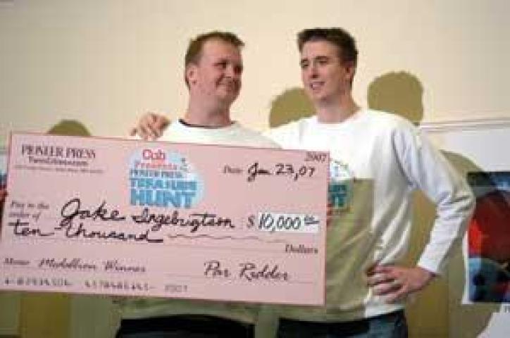 Jake Ingebrigtson, left, looks at his new friend Rob Brass, right, during a press conference at the Pioneer Press in Saint Paul, Minn. Tuesday, Jan. 23, 2007. Ingebrigtson found the Winter Carnival Medallion after Brass shared some of his ideas on cracking a clue. (Brandi Jade Thomas / Pioneer Press)