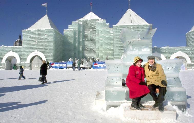 Carnival-goers sit on the ice throne outside the 2004 Ice Palace