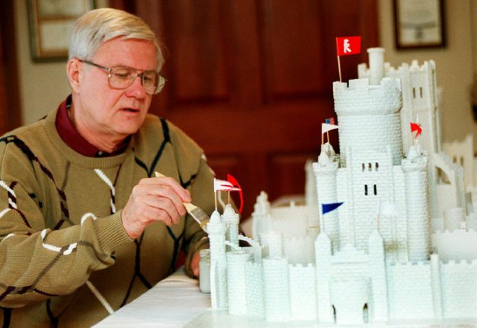 A main paints an Ice Palace model