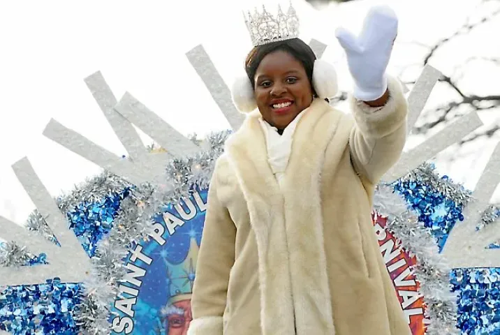 Aurora Queen of the Snows, Krystle Igbo-Ogbonna, waves to the crowds as she rides the Winter Carnival Royal Float in Winter Carnival Grand Day Parade along Seventh Street in St. Paul on Saturday, January 24, 2015. (Pioneer Press: John Autey)