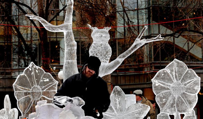 Derek Pasley of St. Paul carves a rabbit for a sculpture called