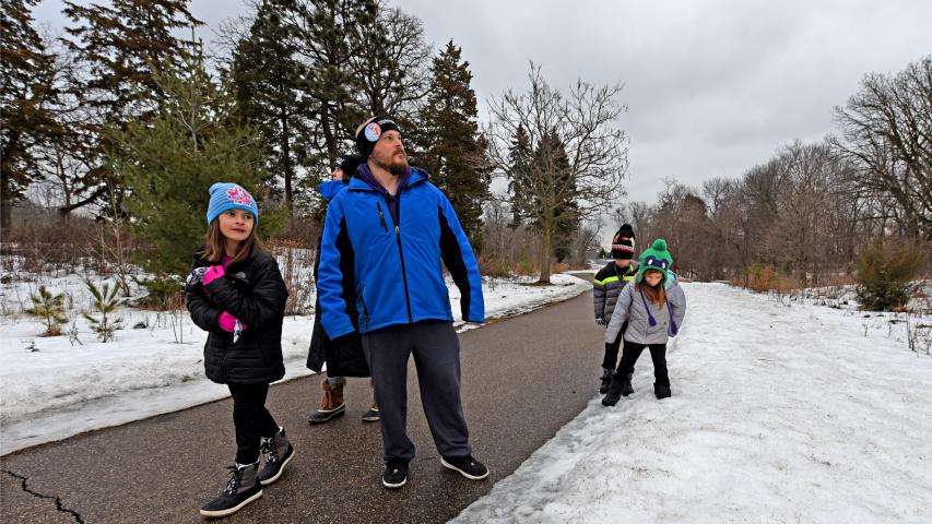 The Buck family of St. Paul surveys the landscape and kicks at a snowbank during the annual Pioneer Press Treasure Hunt at Como Park in St. Paul, Minn., Monday, Jan. 23, 2017. Pictured are, from left: Bella, 10, Shannon, Nate, and 8-year-old twins Judah and Gwyn. (Pioneer Press: Dave Orrick)