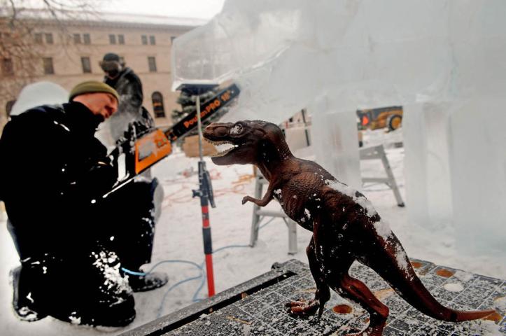 John Njoes of Minneapolis uses a model of a T-Rex dinosaur as he makes a dinosaur for his