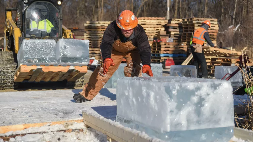 A Park Construction Co. employee monitors a recently cut block of ice harvested on Green Lake in Spicer, Minn., on Wednesday, Jan. 3, 2018. The ice blocks will be shipped to St. Paul, to construct a 70-foot ice palace in Rice Park for the Winter Carnival. (Erica Dischino / Forum News Service)