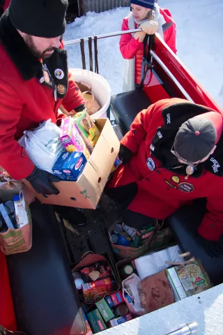 Volunteers helped the Vulcans to pack 2 tons of donated food into five firetrucks on Feb. 23. (Callie Schmidt / Pioneer Press)