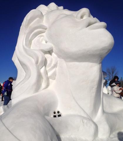 Trophies for the Minnesota State Snow Sculpting Competition's First Place and People’s Choice winner sit at the base of the sculpture "Frozen," by House of Thune team members Dusty Thune, David Aichinger and Jessica Turtle, all of St. Paul. (Courtesy of Winter Carnival)