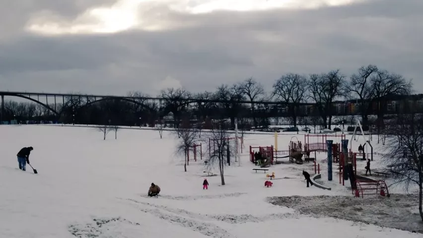 People dig around the playground at Harriet Island Regional Park on Tuesday, Jan. 26, 2016, in hopes of finding the Pioneer Press Treasure Hunt medallion. (Pioneer Press: Jaime DeLage)