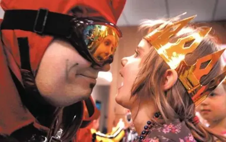 Four-year-old Erin Young gets a close-up view of herself in the goggles of Tim Cole, the Vulcan Duke of Klinker, this week during the Krewe’s St. Paul Winter Carnival visit to Carol Mathey’s Center for Children and Families in Oakdale. (JOHN DOMAN, Pioneer Press)