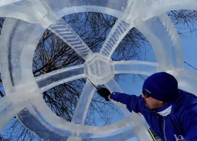 Chris Swarbrick of Richfield cleans up an ice sphere, part of his team's entry, "Fountain of the Unicorns," at Rice Park in St. Paul on Friday January 23, 2008. Judging for the Winter Carnival ice carving competiton takes place at the park on Saturday morning. (Pioneer Press: Richard Marshall)