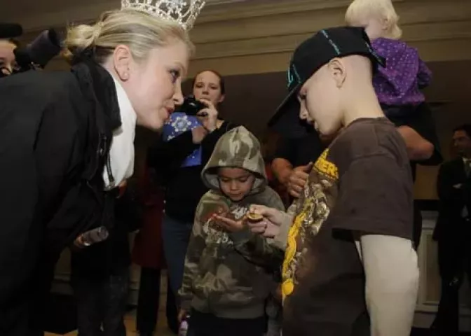 Damon McNamara, a nine-year-old boy from Florida, flew into the Twin Cities Thursday in order to have his dream of a "winter wonderland" fulfilled . 2009 Queen of the Snows Sarah Schweich of Minneapolis handed McNamara a Winter Carnival medallion. Local organizers teamed up with the Florida-based Children's Dream Fund to make the boy's wishes come true. In the center is step-brother Tyler Poling. (Pioneer Press: Scott Takushi)