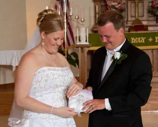 Jake Ingebrigtson, right, and his new wife Sara (Harpestad) Ingebrigtson incorporated the Pioneer Presss Treasure Hunt medallion into their wedding ceremony Saturday, August 7, 2010. Ingebrigtson has found the medallion twice, in 2007 and 2010. Courtesy photo.