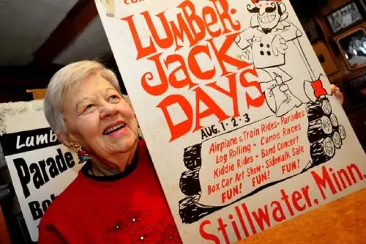Diane Thompson is pictured with a poster that promoted Stillwater s Lumberjack Days in 1968, the year Thompson and her husband, Bob, spearheaded the revival of the community festival. The poster, designed and drawn by former Pioneer Press artist Tim Van Ness, is among the Lumberjack Days memorabilia in Thompson s basement recreation room.