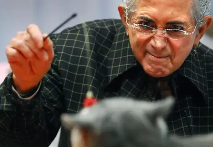 Judge Walter Hutzler of New York City tries to get a reaction out of a cat on his judging table during the Saintly City Cat Club cat show at the RiverCentre in St. Paul, Minn., on Sunday, February 1, 2009.
