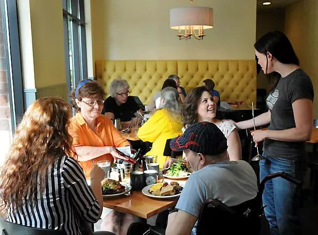 Alicia Hinze, right, pastry chef and co-owner of The Buttered Tin, a new bakery and cafe in Lowertown talks to customers Thursday July 25, 2013. (Pioneer Press: Jean Pieri)
