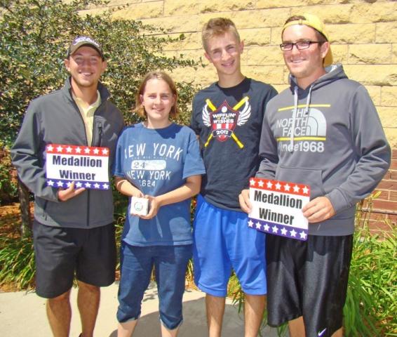 Chris, Natalie and Tommy Sticha (left to right) teamed up with Jake Rosen (far right) and Austin Daniel (not pictured) to find the 2013 Lakefront Days medallion at Spring Lake Regional Park, about 100 feet from County Road 12 and about 100 feet from the western-most trail at the park. The medallion was hidden between two rocks and under a piece of bark.  Submitted photo