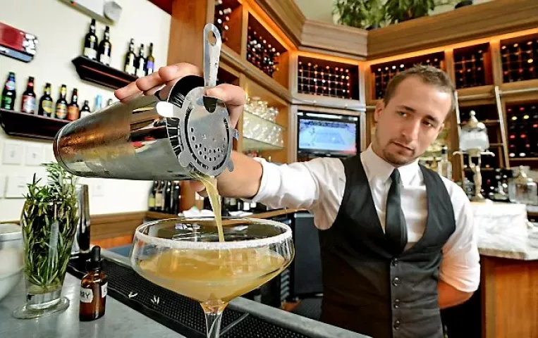 Bartender Matthew Barthelemy pours a freshly mixed Pimm's Provencal at the Meritage in St. Paul on Wednesday September 5, 2012. The drink is made with lavender-infused Bombay Sapphire, Pimm's No. 1, and elderflower and cherry bitters. (Pioneer Press: Richard Marshall)