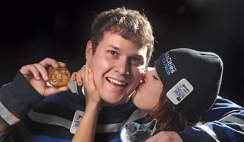 "My adrenaline is kind of peaking right now," said 27-year-old Benjamin Haselman of St. Paul, who gets a smooch from his 25-year-old sister Jillian, right, after finding the St. Paul Pioneer Press Treasure Hunt Medallion in St. Paul's Como Park on Monday morning, January 27, 2014. (Pioneer Press: Richard Marshall)