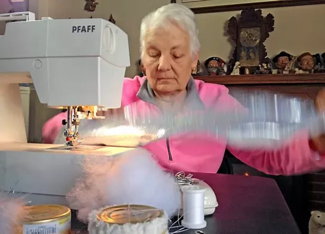 73-year-old Flo Dougherty runs one of her latest cat capes for the 2015 Saintly City Cat Show through her sewing machine at her home in White Bear Lake on Friday, February 7, 2014. Dougherty has crafted the outfits for the winners of the annual cat show for the past seven years out of cloth, bells and empty cat food cans. (Pioneer Press: John Brewer)