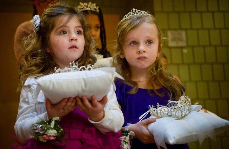 Four-year-olds Madeline Flynn, left, and Makenna Flaherty wait to be introduced as the honorary gift bearers at the start of the Senior Royalty Coronation ceremony. (Pioneer Press: Ben Garvin)