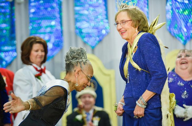 Jackye Whitner, left, the outgoing 2013 Queen of the Northlands, pays deference to the new queen, Gerry Schulz, during the Senior Royalty Coronation ceremony. (Pioneer Press: Ben Garvin)