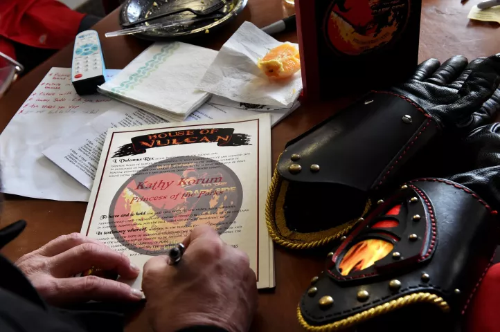 John Utermoehl, Vulcanus Rex, signs a knighting certificate before heading out with the Vulcans on a day with 13 scheduled appearances. (Pioneer Press: Jean Pieri)