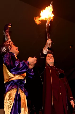 The outgoing Prince of the East Wind: David Medernach, left, lights the 201t6 Euros, Prince of the East Wind, Duane Tesser's sword on fire at the St. Paul Winter Carnival Royal Coronation at the St. Paul River Centre on Friday, January 29, 2016. (Pioneer Press: John Autey)