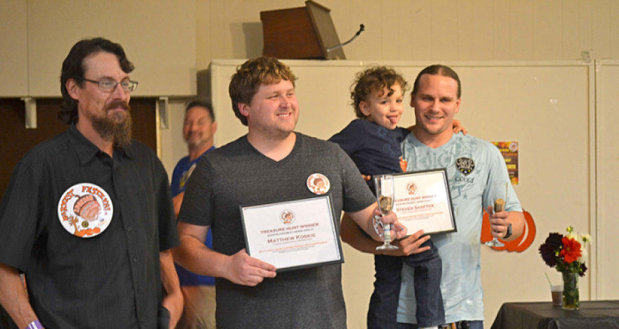 From left to right, Harvest Festival medallion hunt clue-writer Ed Brodie, and medallion hunting team Matt Koskie, Skylar and Steven Sanfter, were recognized at the Harvest Festival kick-off dinner on Sept. 20. Koskie and Sanfter found the medallion in Swede Hollow Park on Sept. 17. Marjorie Otto/Review