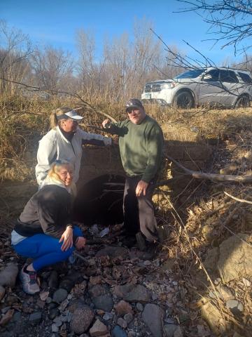 The 2024 Belle Plaine Shamrock Medallion finders pose at the site of the find.