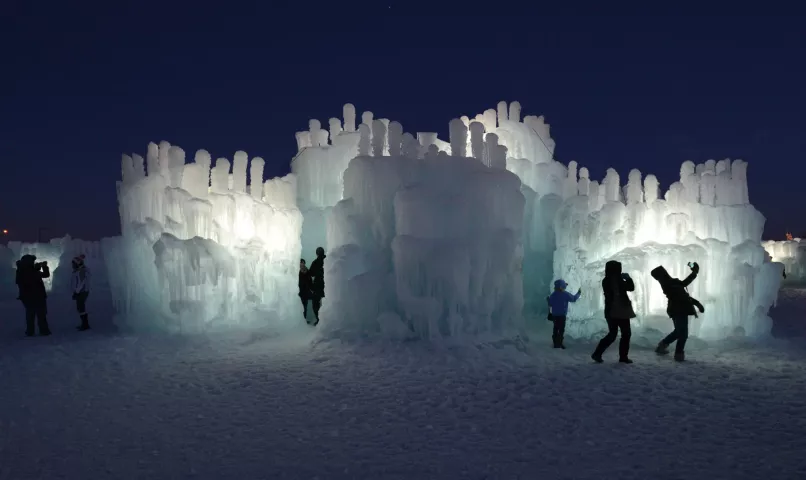 As night falls Monday, December 31, 2012, visitors snap pictures at the Ice Castle at the Mall of America. (Pioneer Press: Chris Polydoroff)