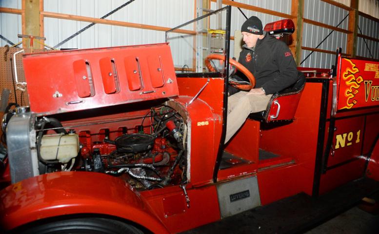 Dave Breen, a Roseville firefighter and Vulcans caretaker of "Luverne," starts the 1932 Luverne Fire Truck in its garage in Vadnais Heights on Tuesday, November 11, 2014. The St. Paul Winter Carnival Vulcans use the truck for events and celebrations and are trying to raise money for $30,000 in needed repairs and maintenance. (Pioneer Press: John Autey)