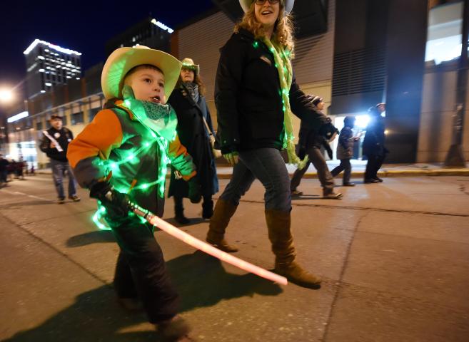 Marchers head up Sixth Street toward Rice Park during the St. Paul Winter Carnival Moon Glow Parade in St. Paul on Thursday, January 28, 2016. (Pioneer Press: John Autey)